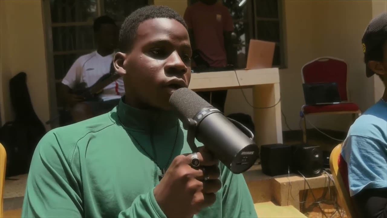The SandBox Ug recording a live session - a vocalist at the microphone with a bassist playing behind her.